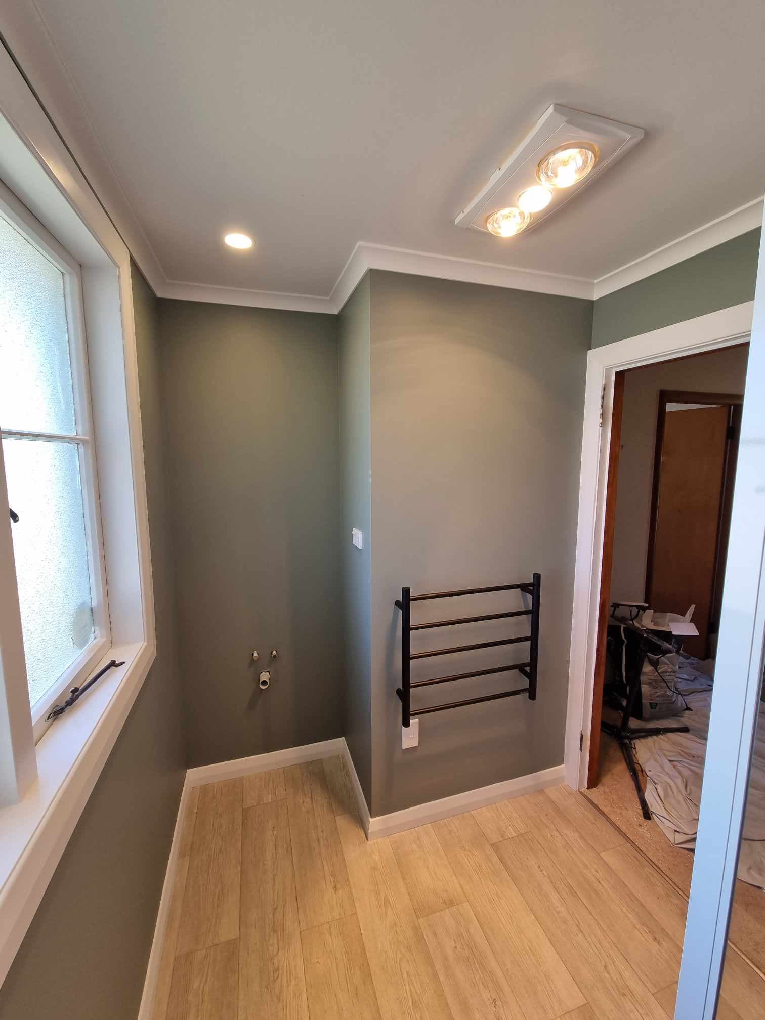 Renovated bathroom with 3-in-1 heater unit and heated towel rail wiring