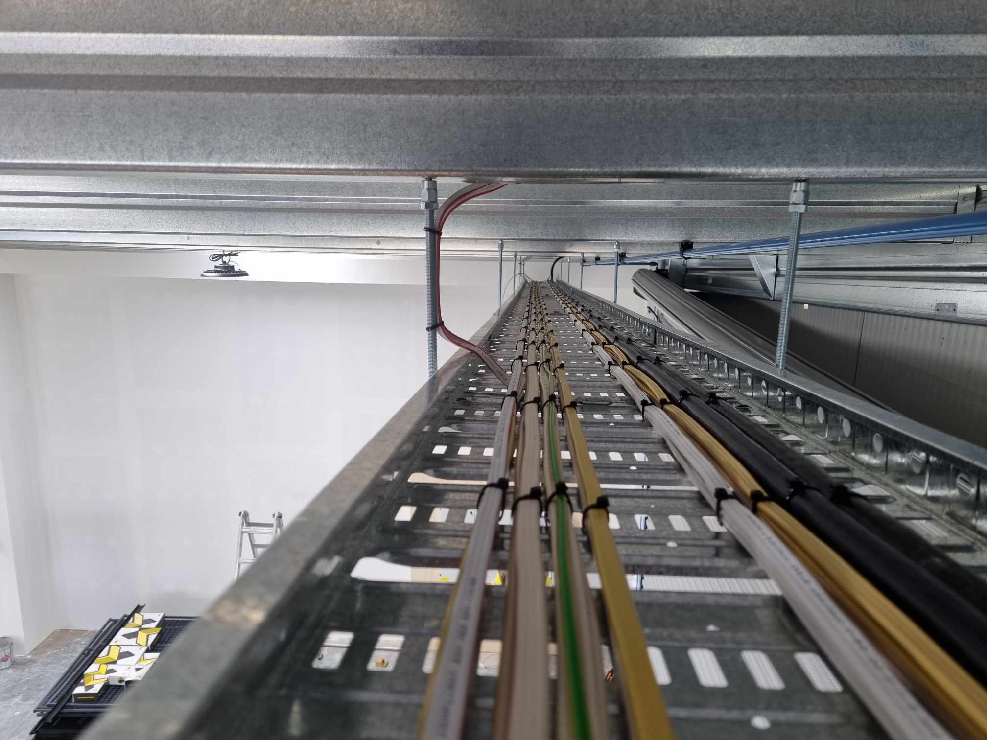 Cable tray runs with tidy cabling through a commercial ceiling space