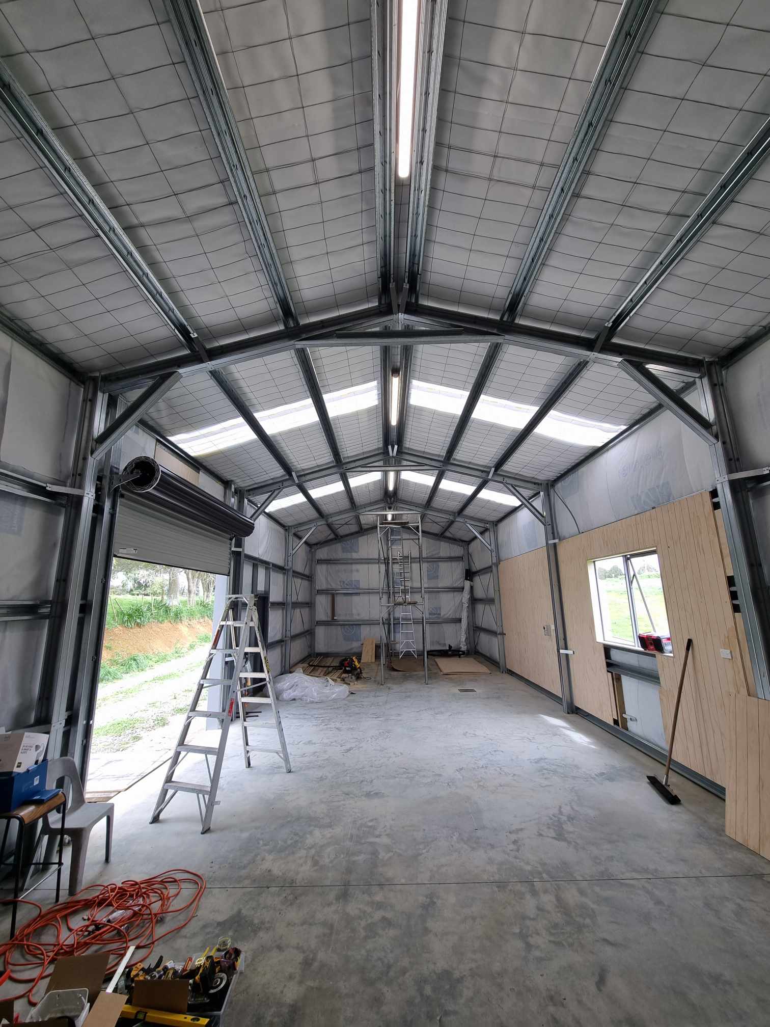Steel shed wired with LED batten lighting and roller door power