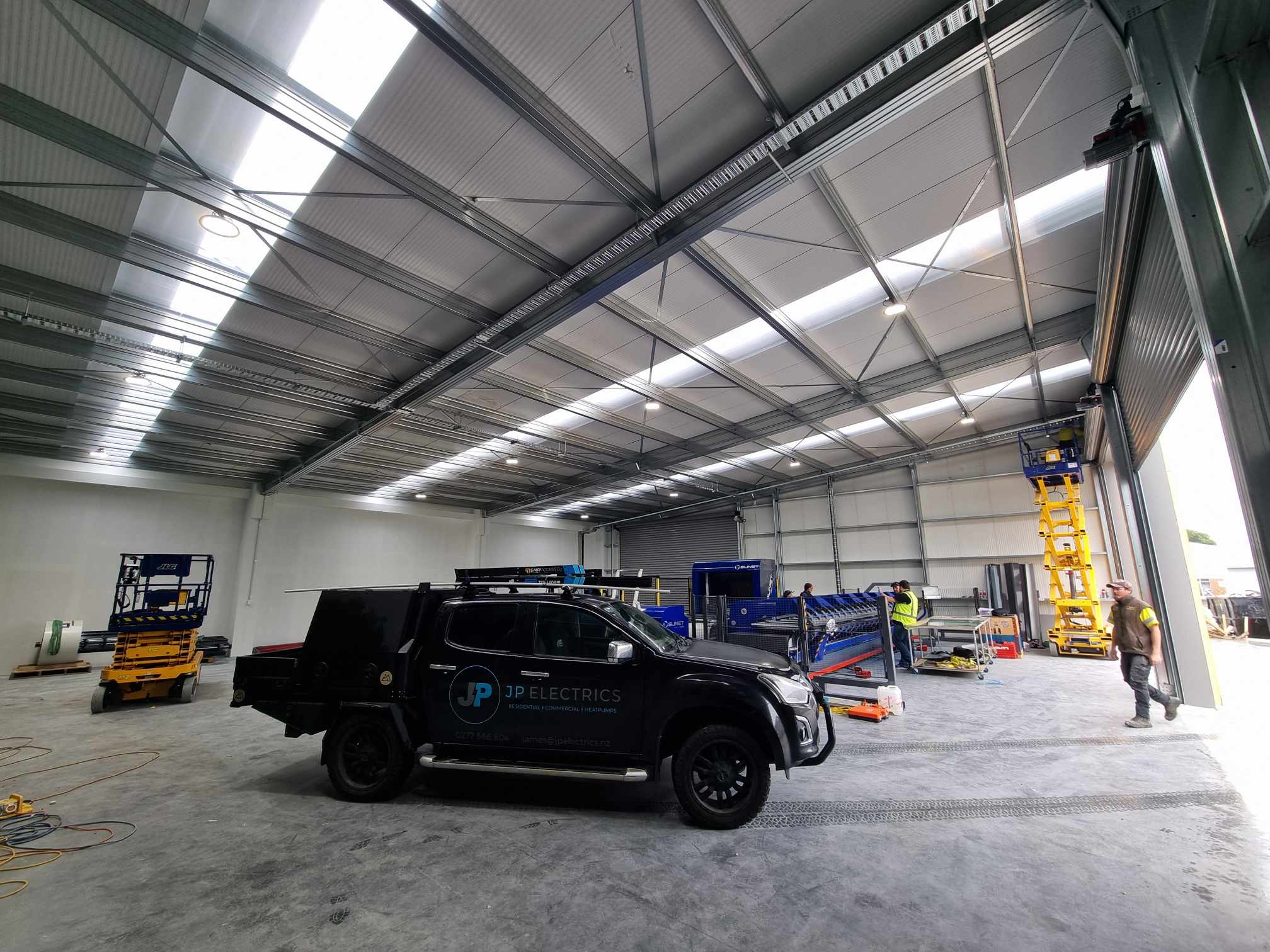 Warehouse electrical fit-out with LED high-bays and skylight bays