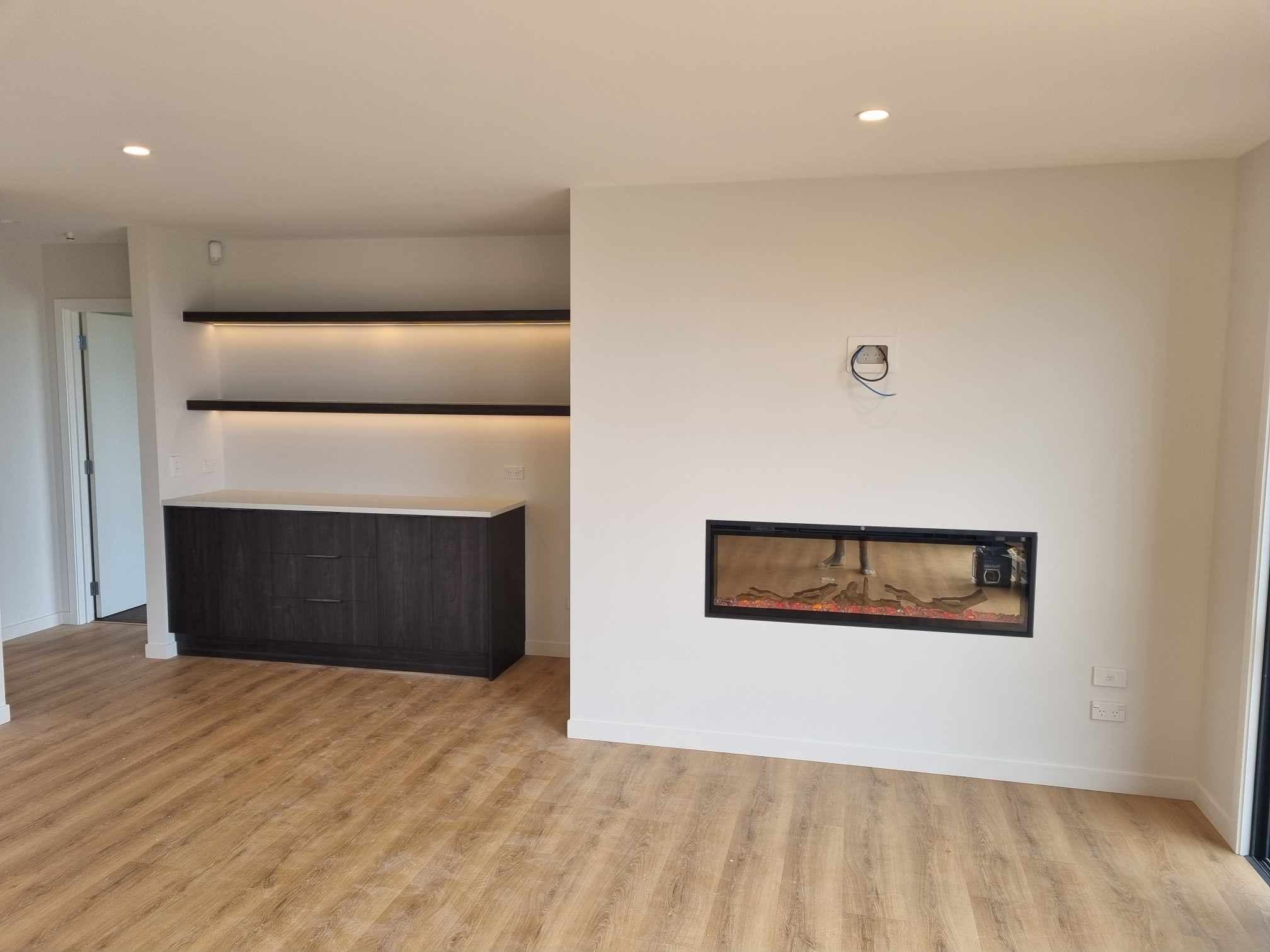 Floating shelves with concealed LED strips and a built-in electric fireplace