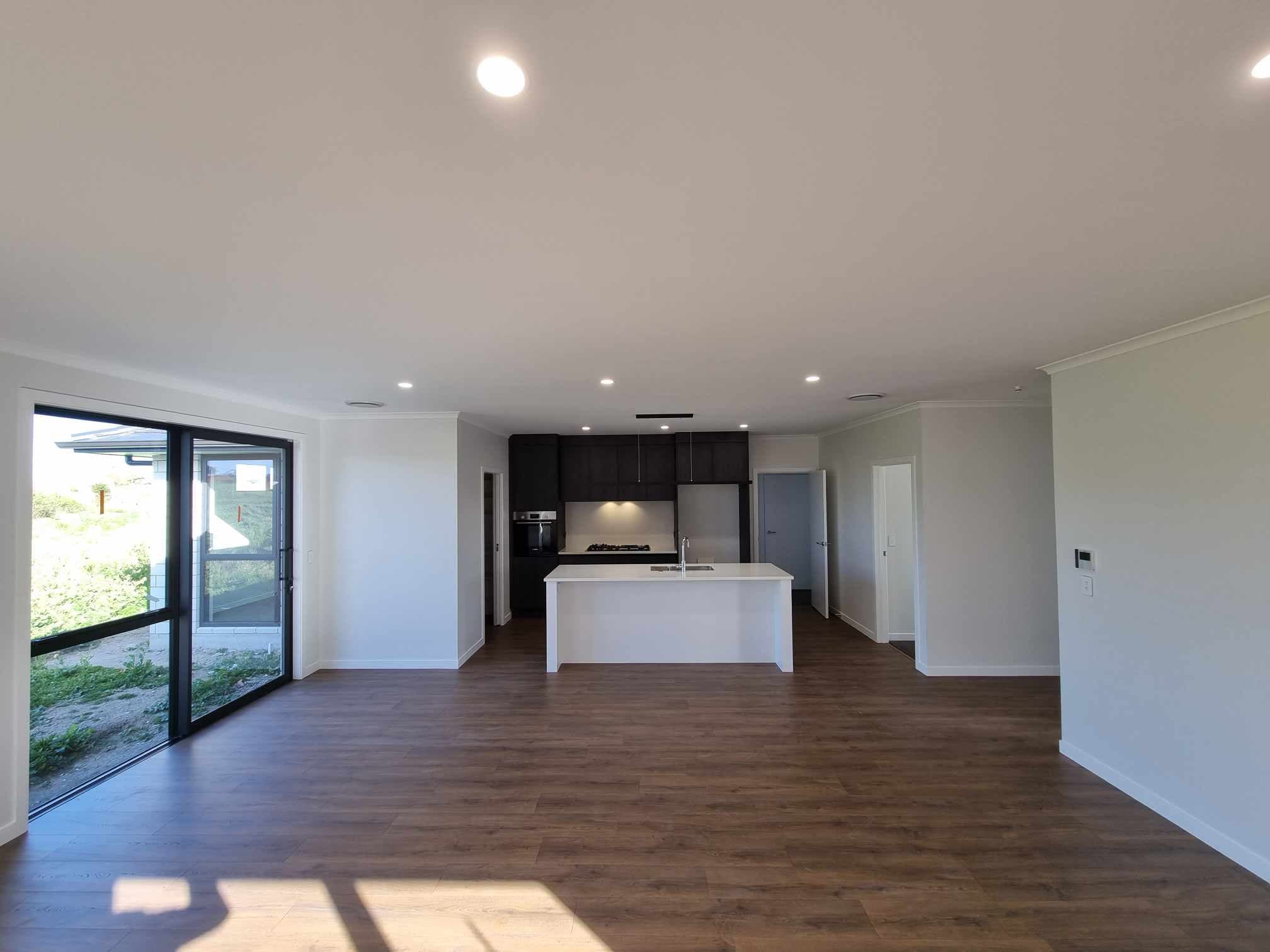 Open-plan new build living area with recessed LED downlights